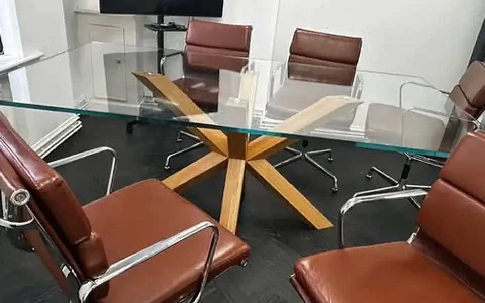 Office meeting room with glass table and leather chairs after cleaning